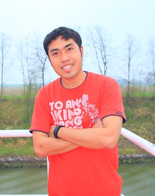 Gibi wearing red t-shirt standing on the starboard bridge wing.