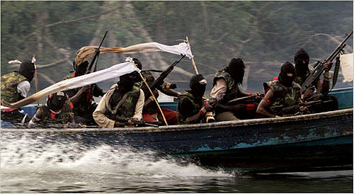 A band of armed pirates riding on a wooden speedboat.