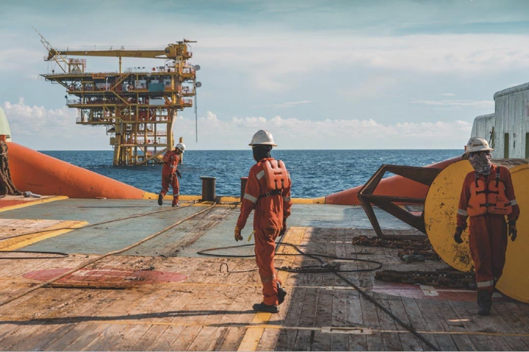 An offshore crew working on the deck of a ship.