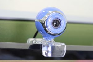 A light blue circular web cam that looks like an eyeball.