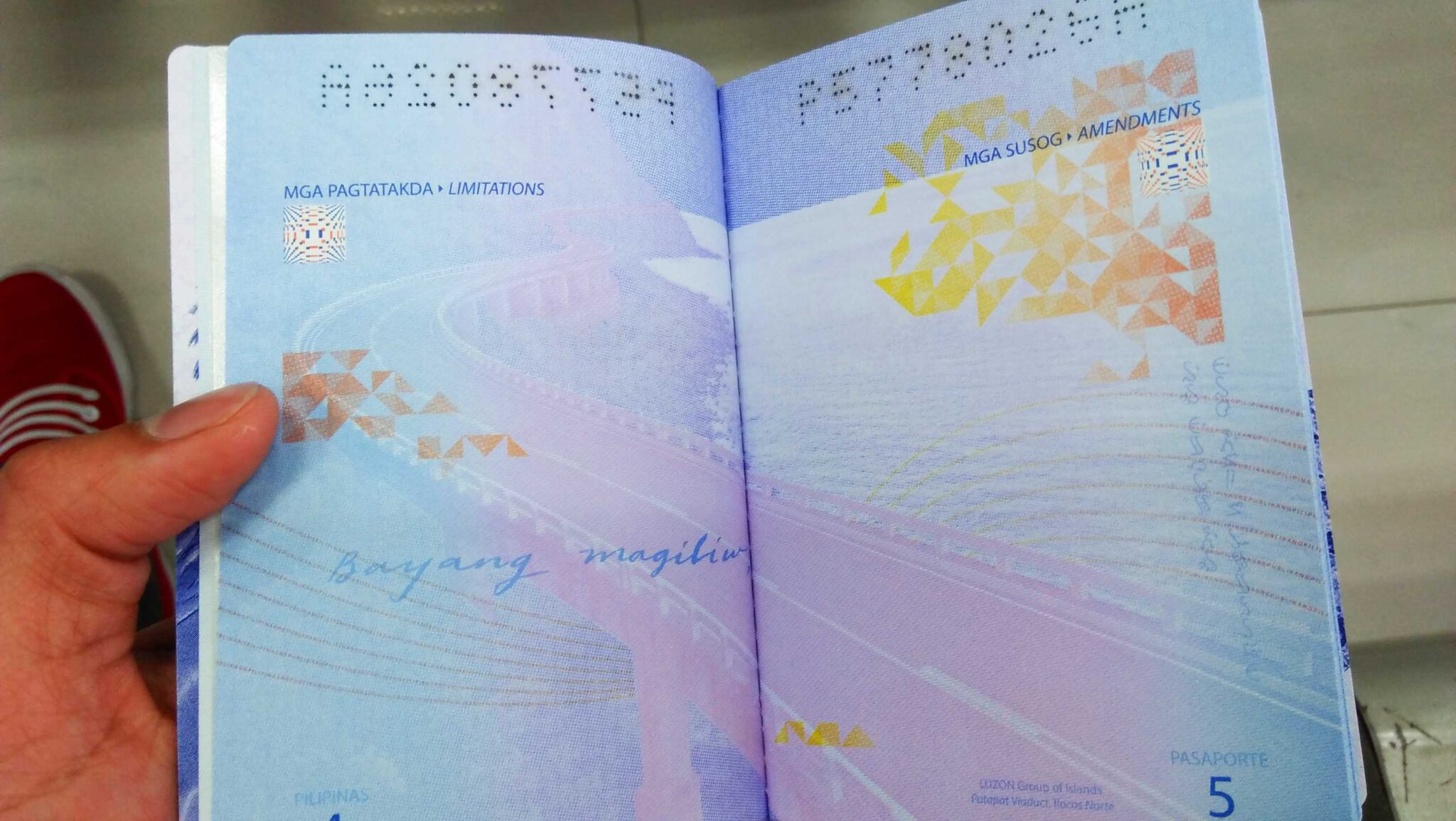 Sample page of our new Philippine passport with lines from our national anthem.