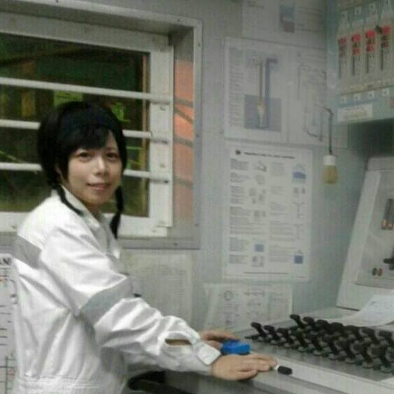 Hiroka Suzuki wearing white coverall inside the Cargo Control Room.
