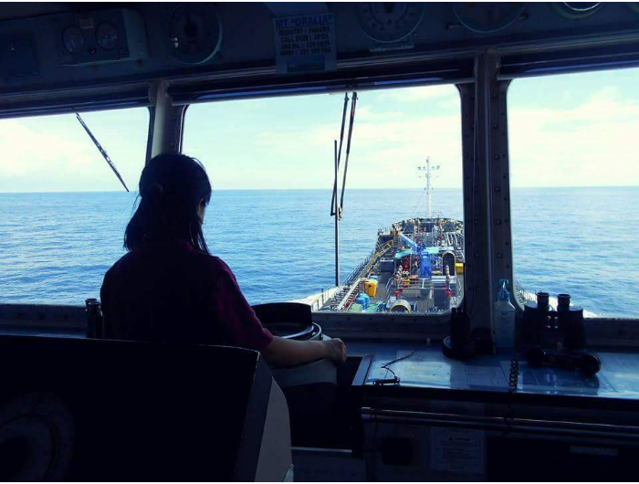 In the ship's bridge navigating in to the open waters during a calm weather.