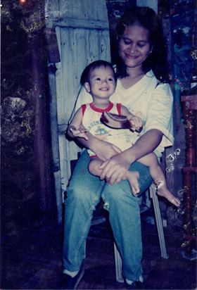 Mom holding her son when he was just a kid.