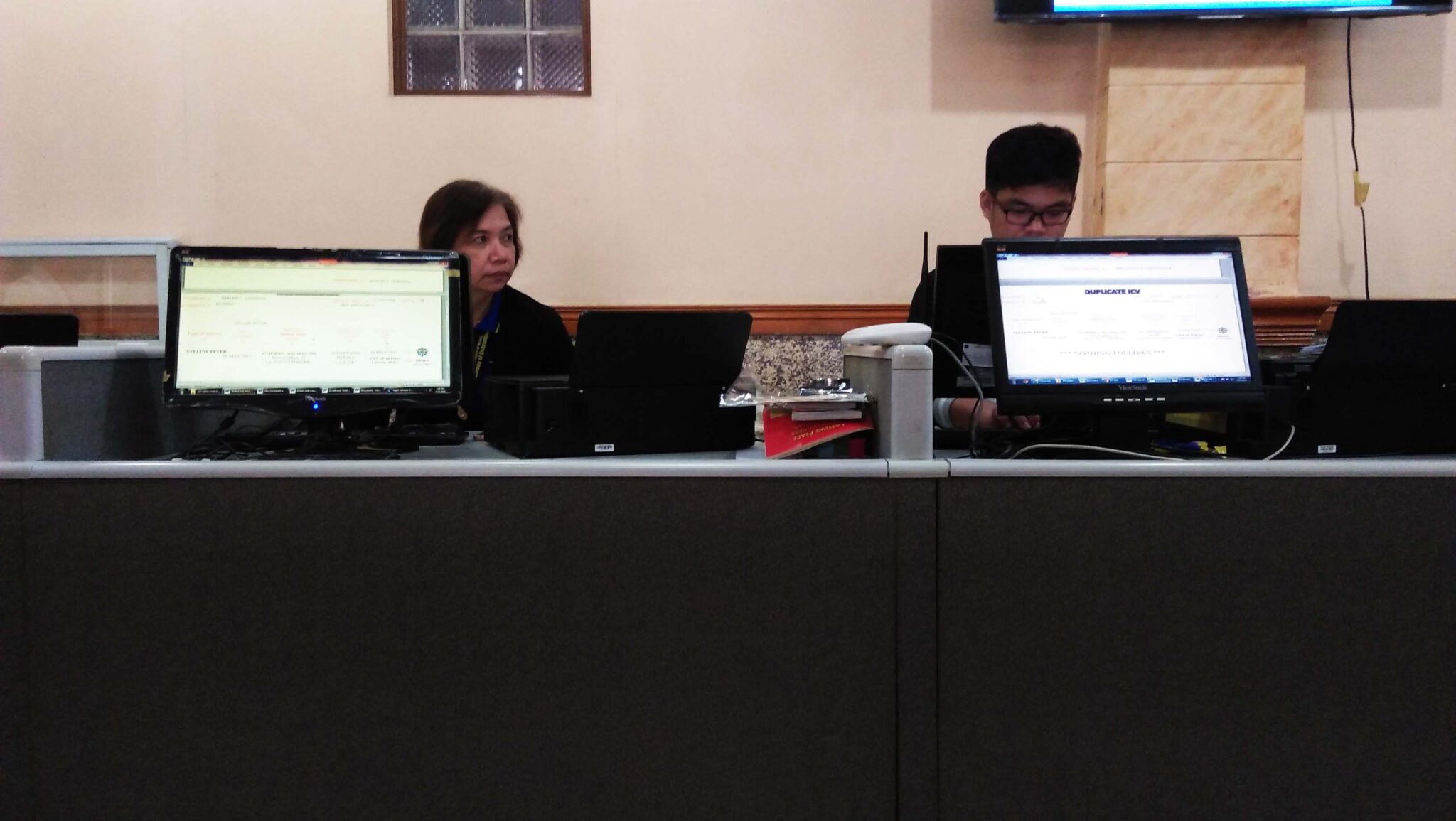 Two staffs with their computers working in the Biometrics Section.
