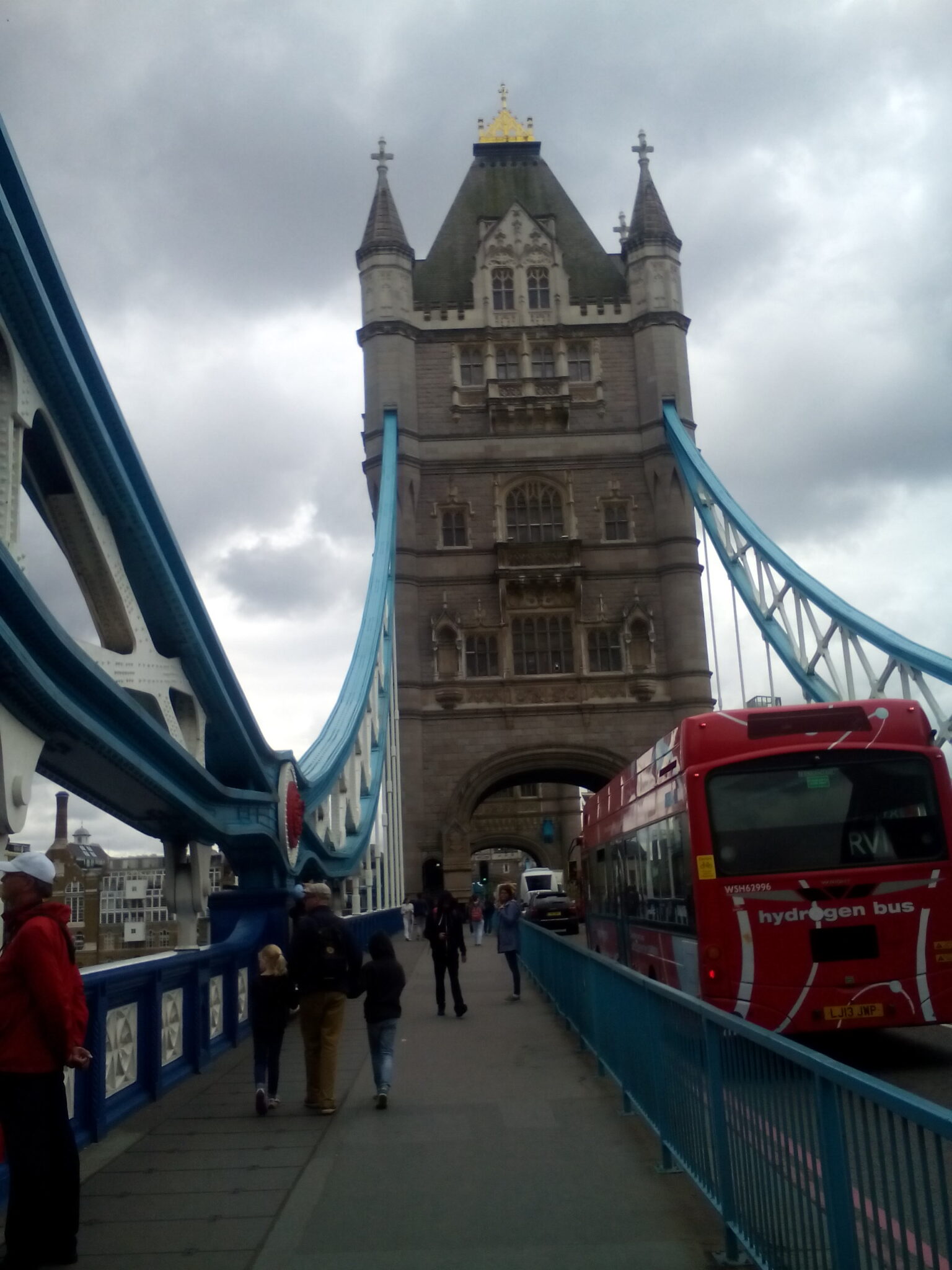Walking on the Tower Bridge while watching one of its enormous tower.