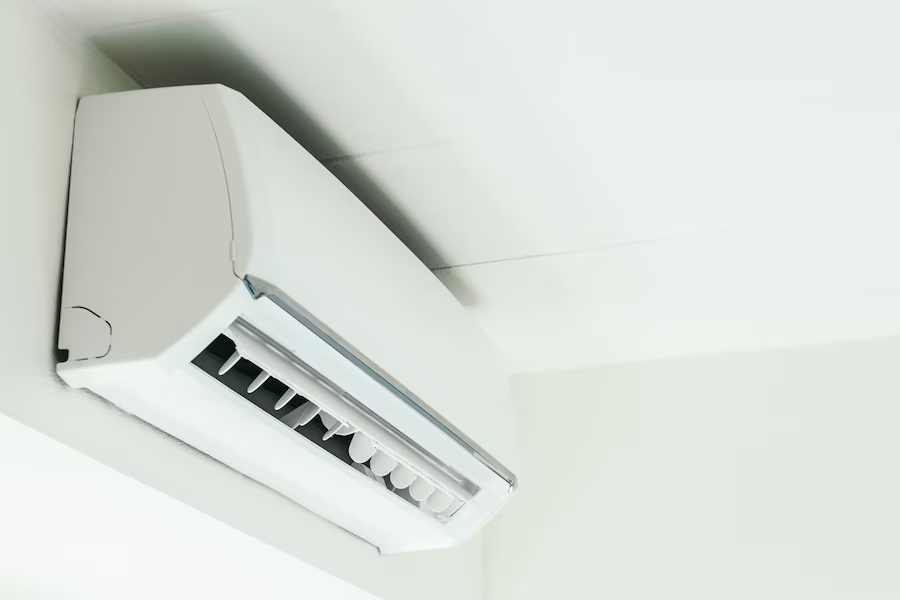 A white air-conditioner installed on the wall.