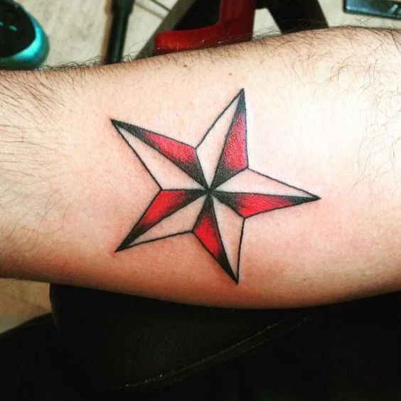 A mariner's nautical star tattoo in his arm.