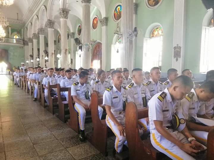 Maritime students sitting inside the church during mass.