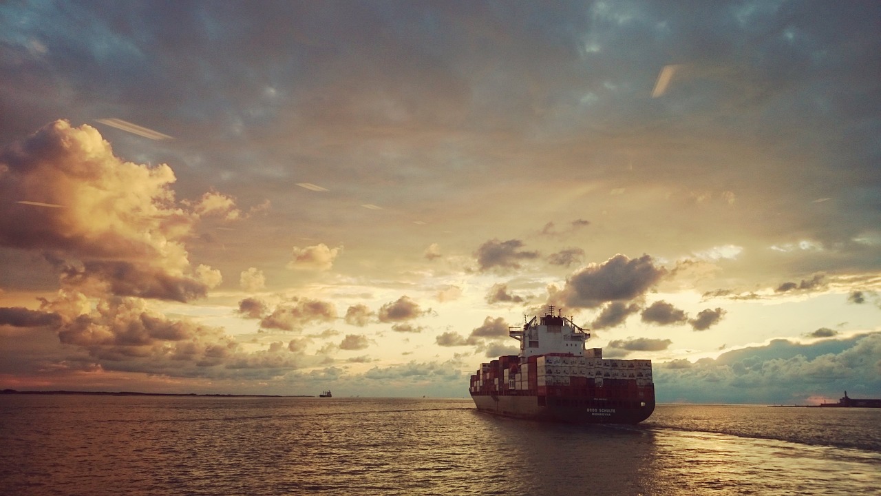 A container ship at sea during an afternoon sky.
