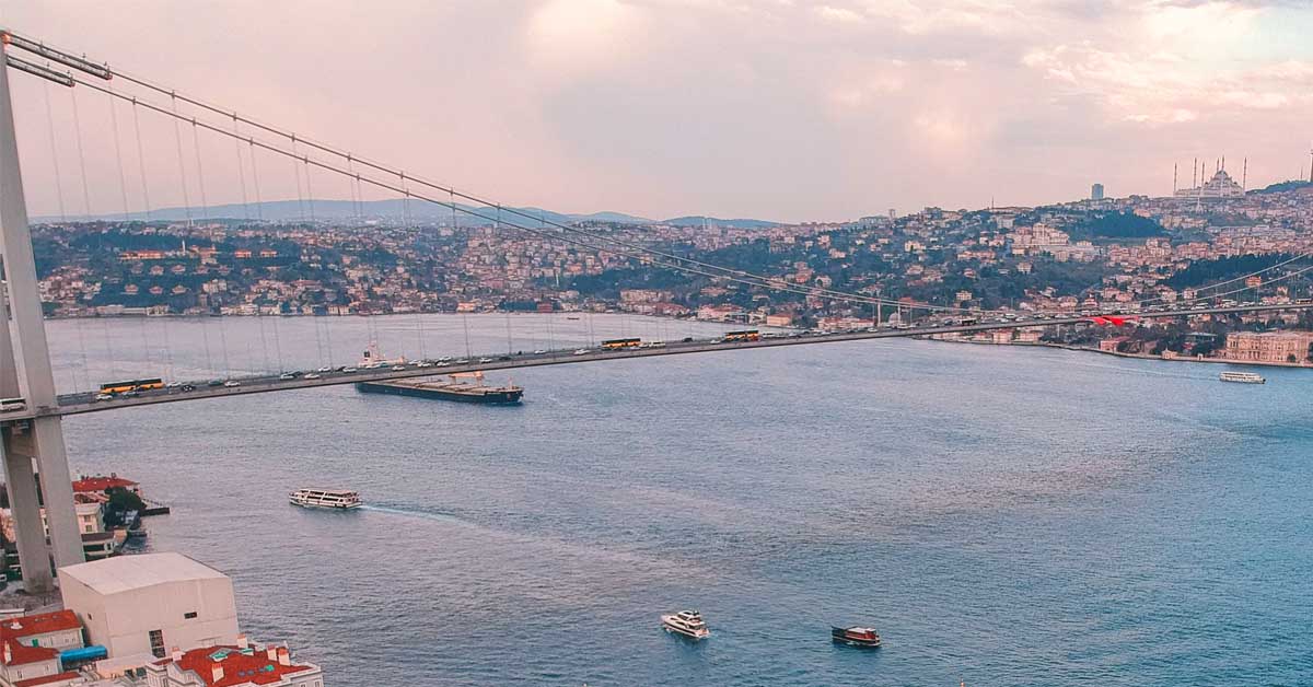 A ship going to the Black Sea is passing under the bridge in Bosphorus Strait.