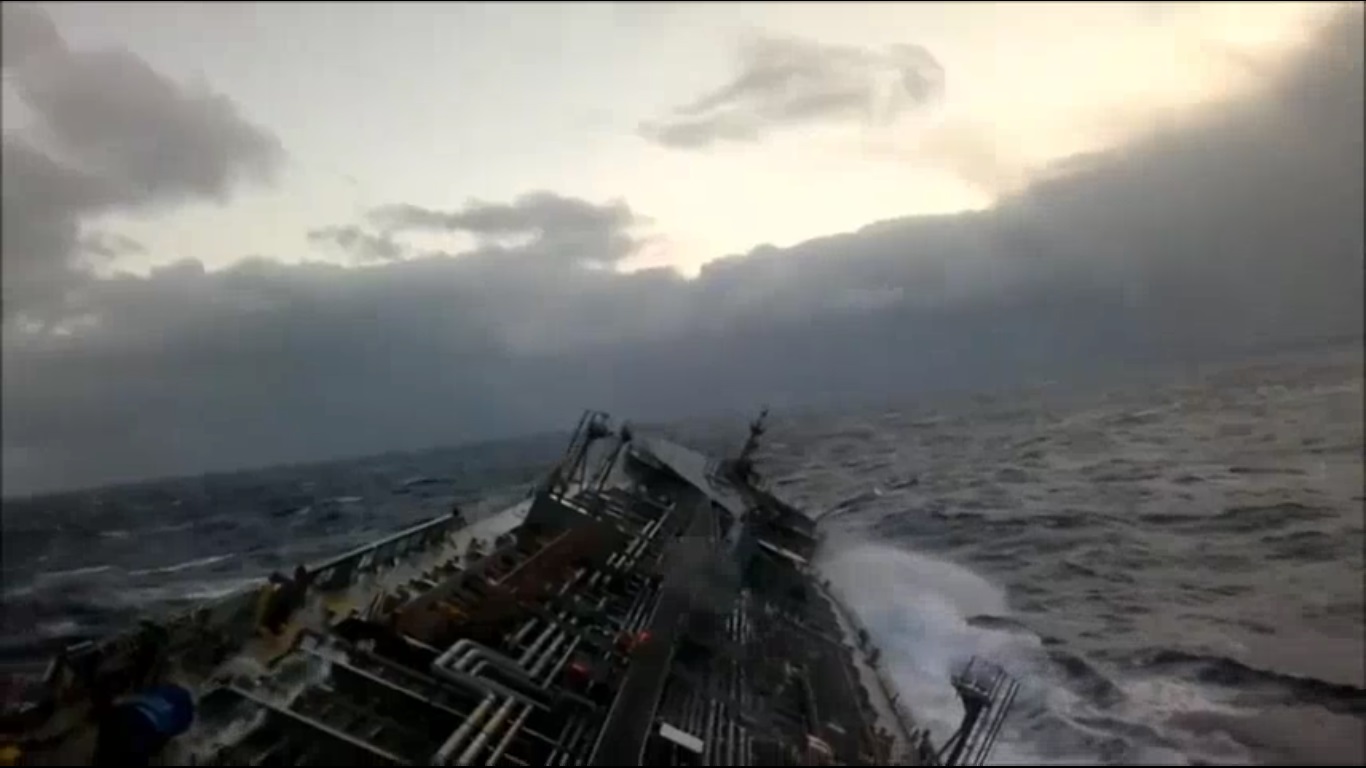A ship in the open sea rolling heavily to starboard.