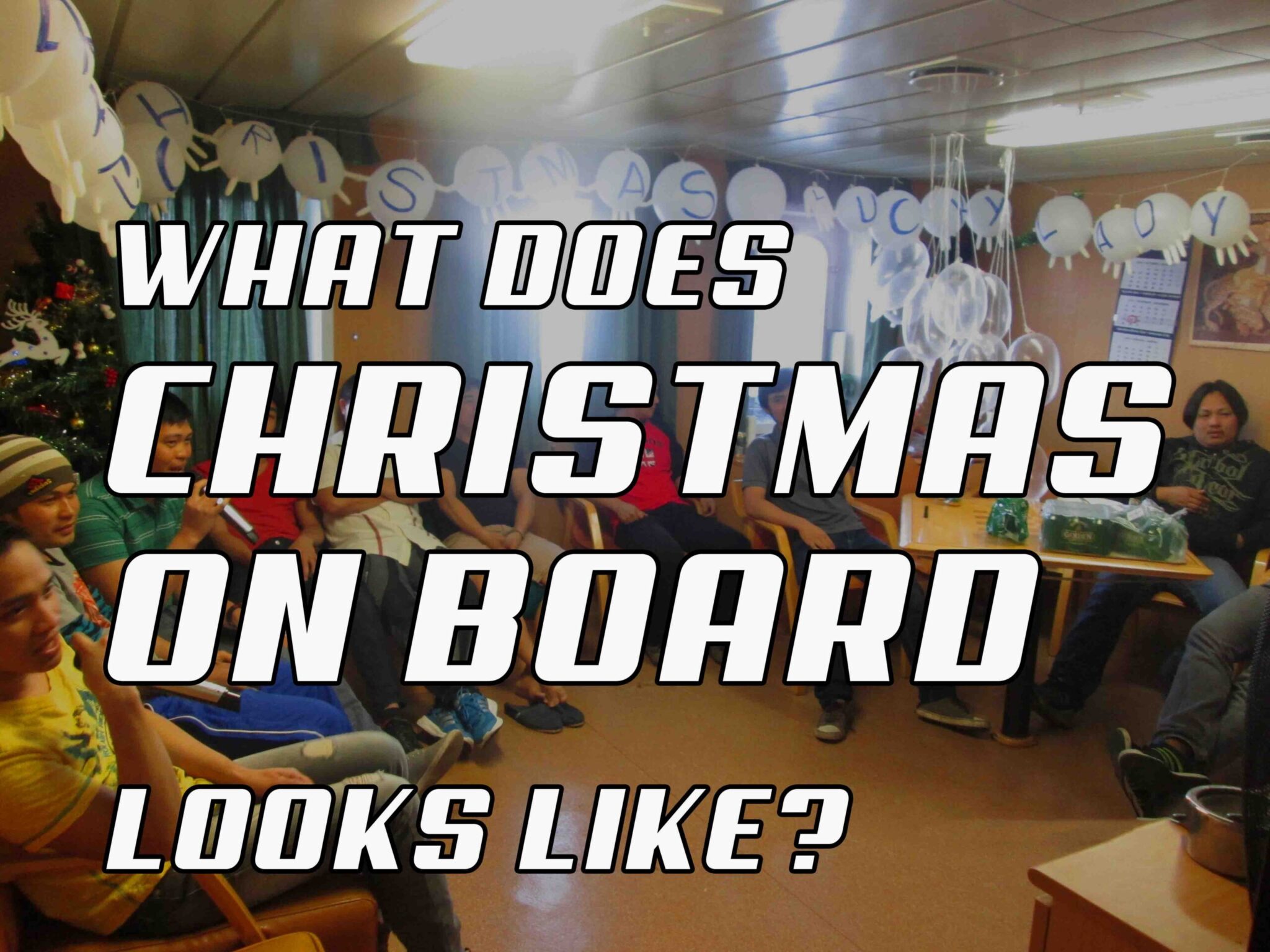 Cover image of the article, "What Does Christmas On Board Looks Like?" featuring the all the crew inside the dayroom.
