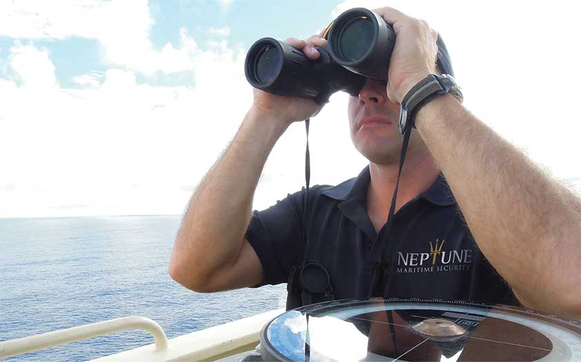 Neptune Maritime Security personnel using a binocular to check threats around the ship.