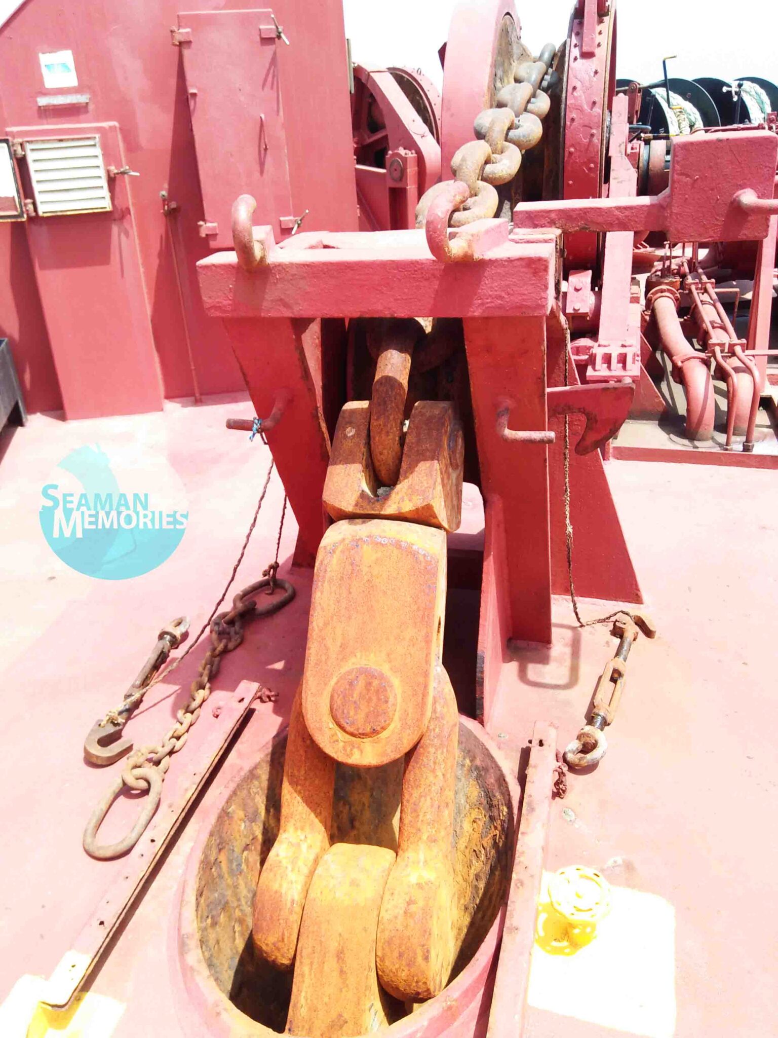 Port side anchors unlashed with its stopper still in position, break made fast, gears disengaged, and the lashings placed on deck