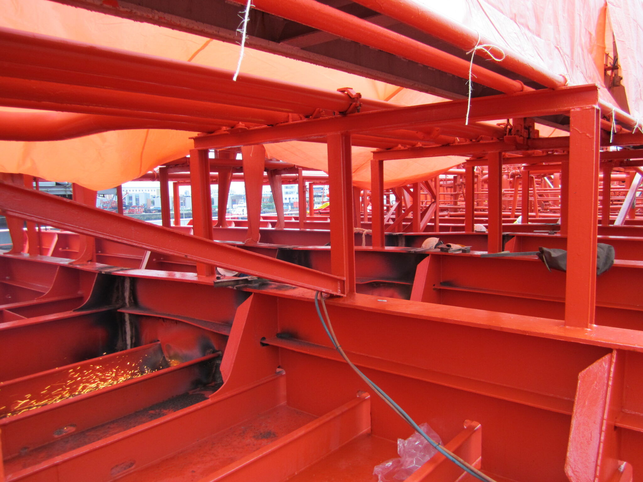 Frame deformation on the deck of a tanker vessel due to over pressurization of cargo tanks. You can see the beams and deck bulging and buckling.