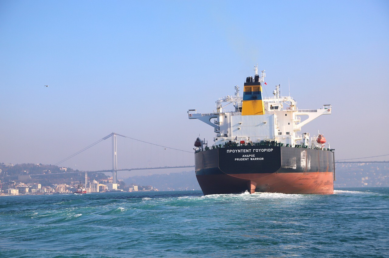 A tanker transiting along the Istanbul Strait with the magnificent views around and a bridge up ahead.