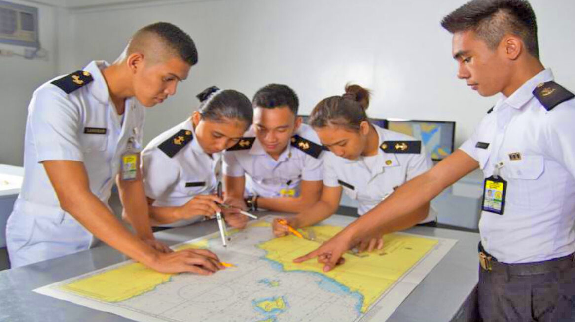 Cadets enhancing their skills in using a nautical chart.