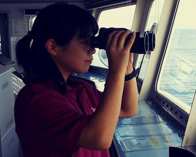 Female look out in the bridge using binocular
