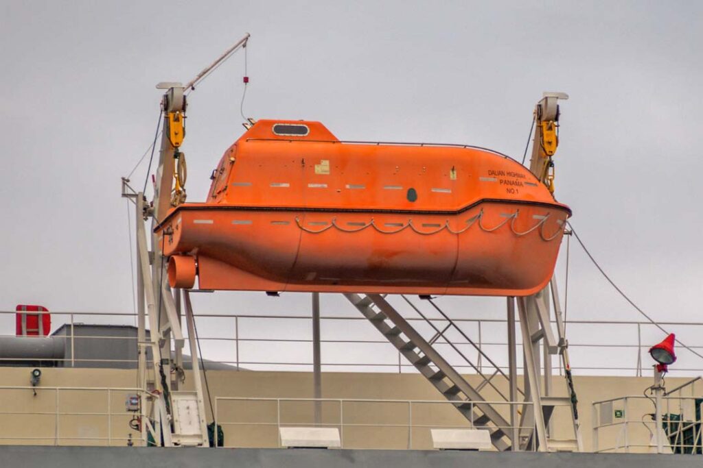 A Davit type, Totally Enclosed Lifeboat hanging on its securing arrangement.