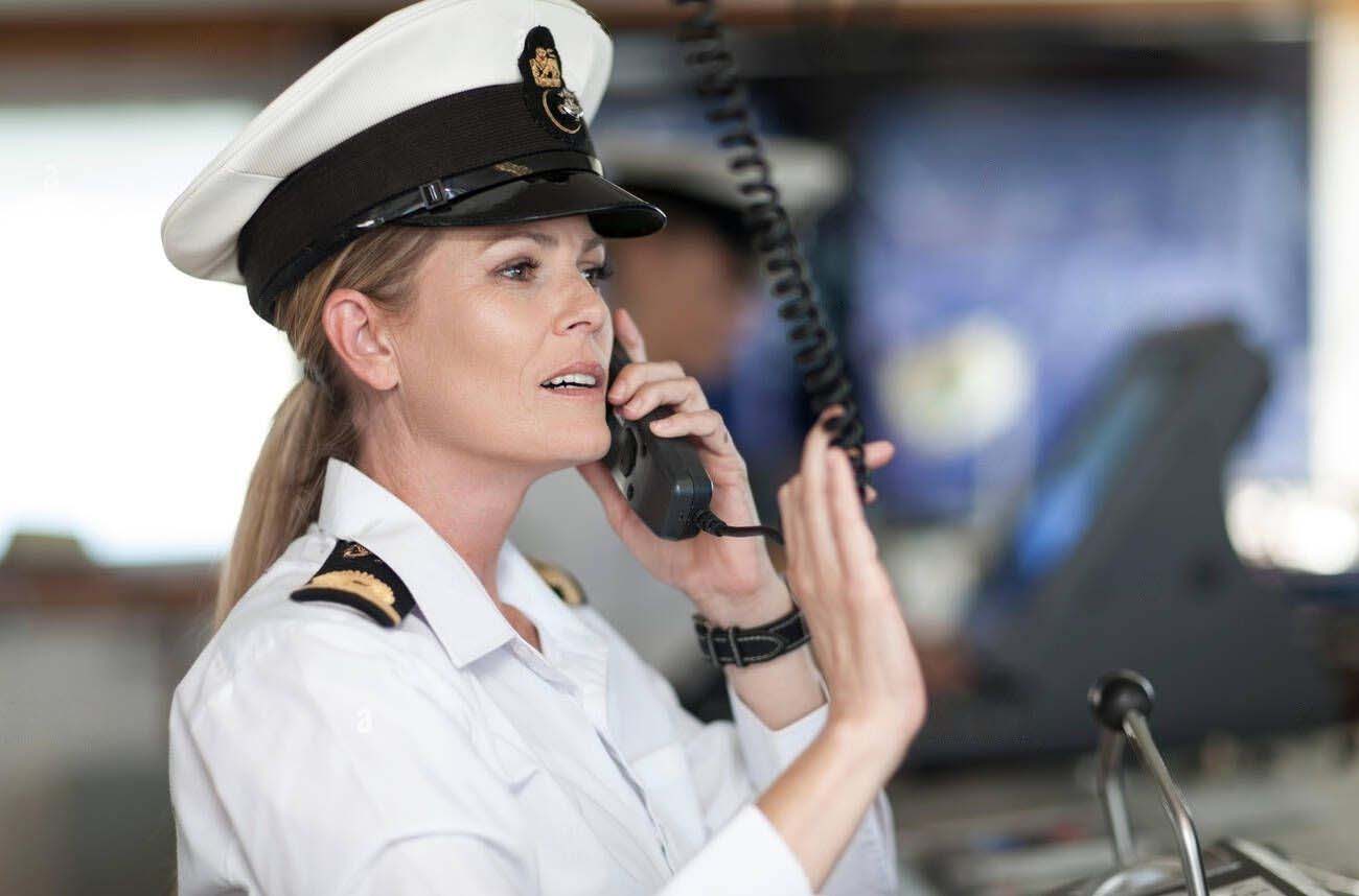 A ship's officer calling other vessels using marine radio.