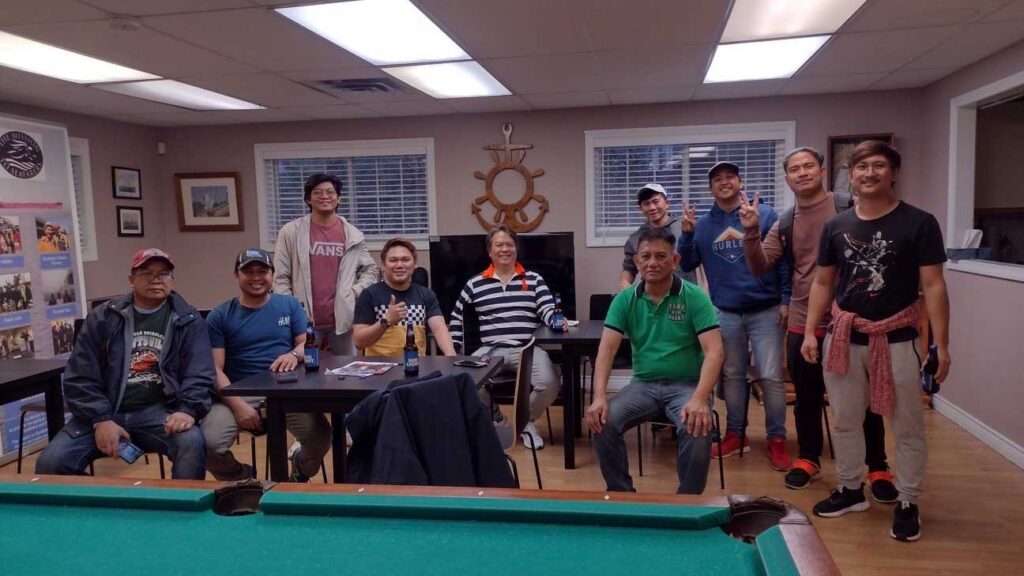 Seafarers enjoying their stay in the Mission To Seafarers Halifax with billiards and drinks.