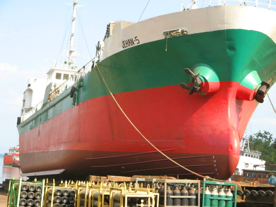 A huge vessel newly painted with red hull and green upper hull.