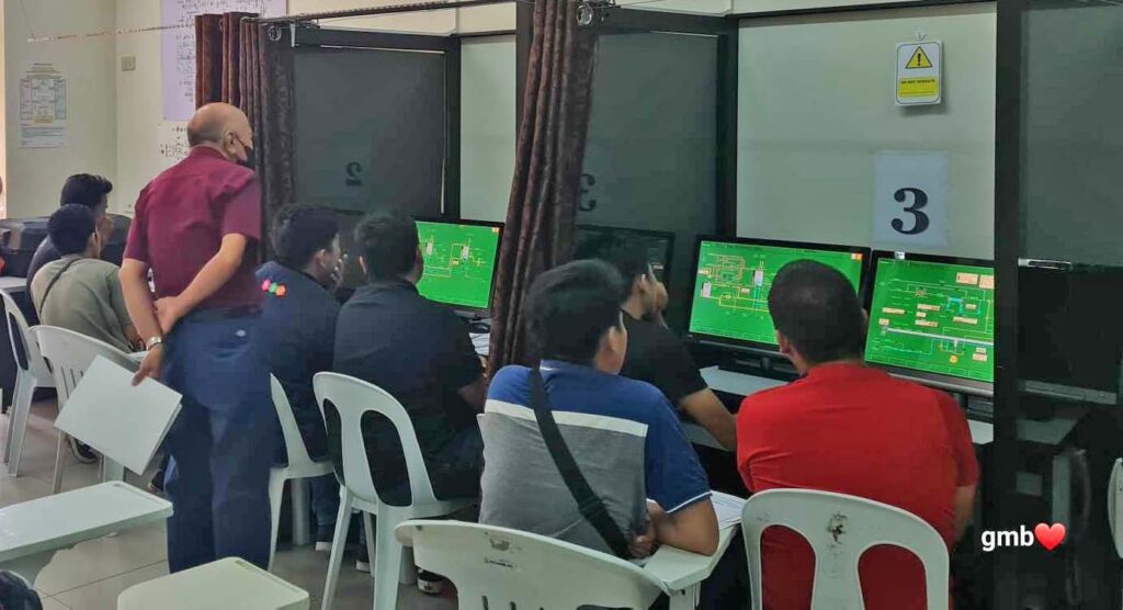 Seafarers performing cargo operation in a computer simulator during their training.