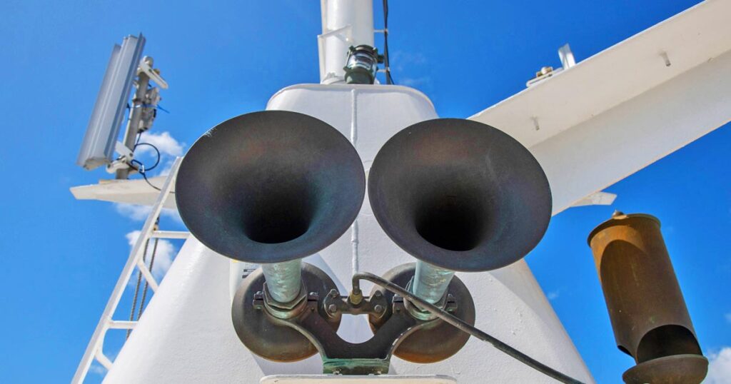 Two ship's whistle installed side by side on the ship's mast.