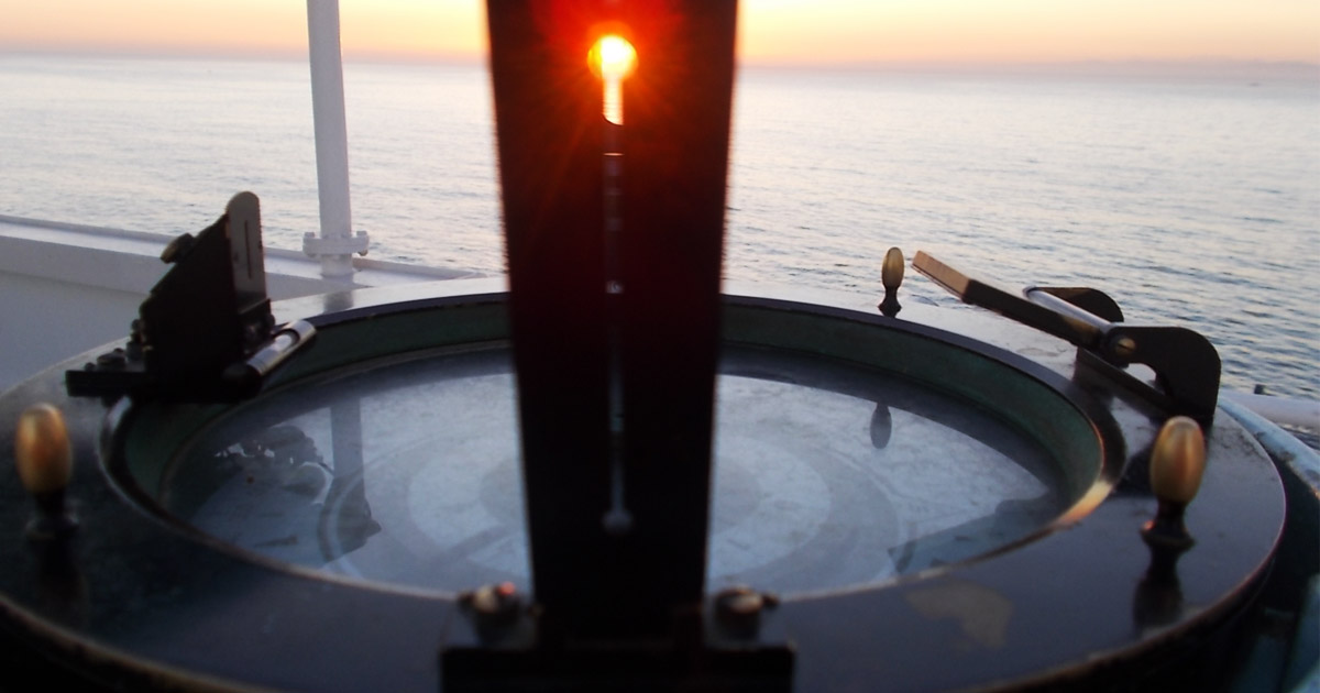 Taking a bearing of the sun using the gyro compass.