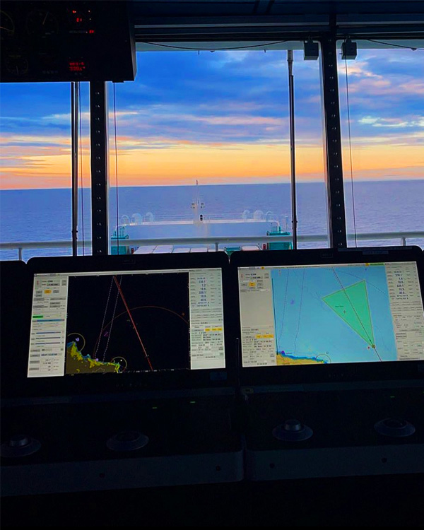 Two ECDIS installed on a vessel navigating in an open sea.