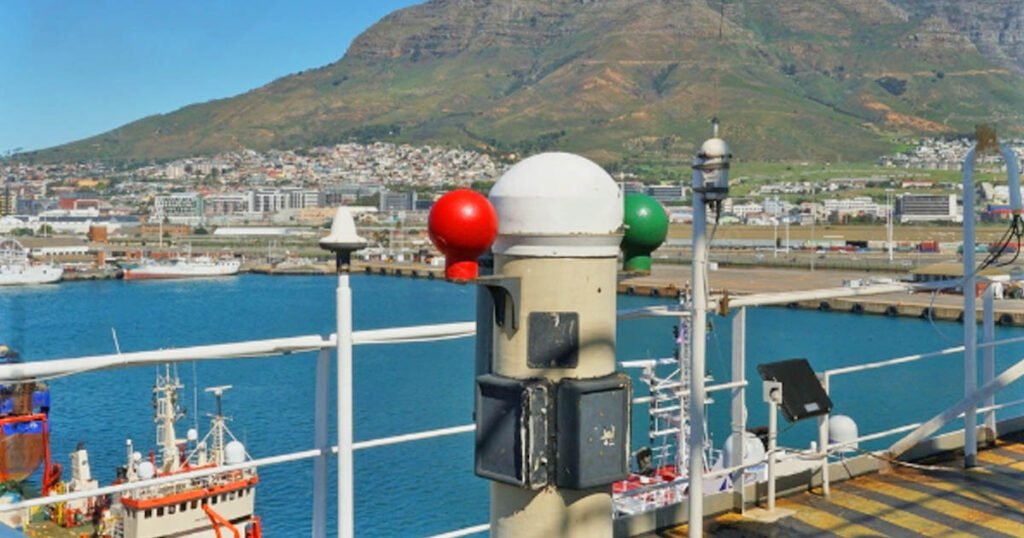 A standard magnetic compass installed on the monkey island with its soft iron spheres colored green and red.