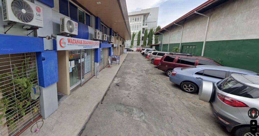 View of Watanak Diagnostic Center Bacolod Branch with cars parked in front.